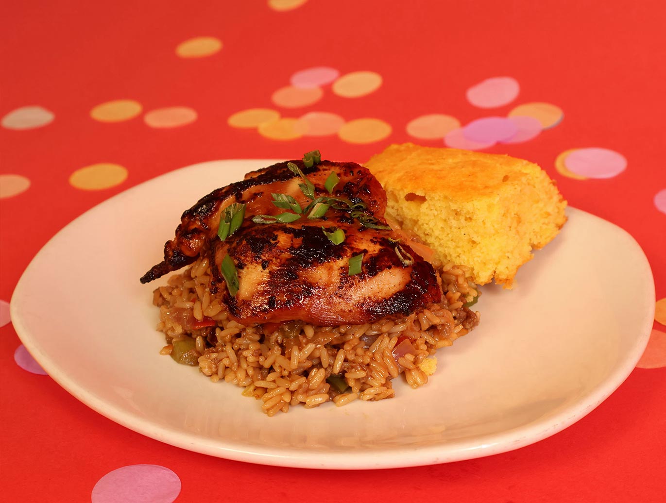 Boardwalk BBQ Knotts Berry Farm Boneless Honey Garlic Chicken Thighs over Dirty Rice with Cornbread